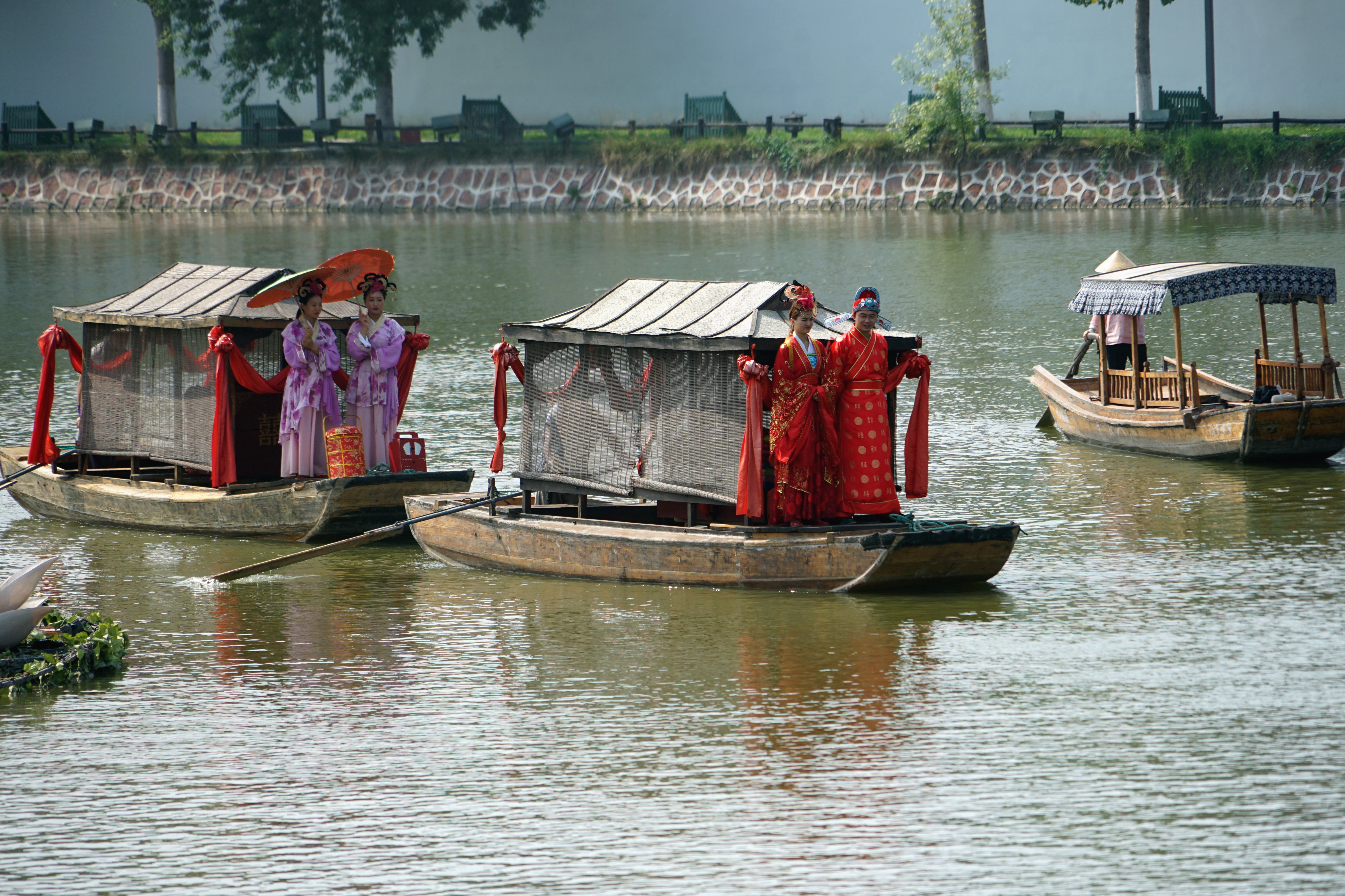 原处来了一支迎亲的队伍,几个人站在船头.